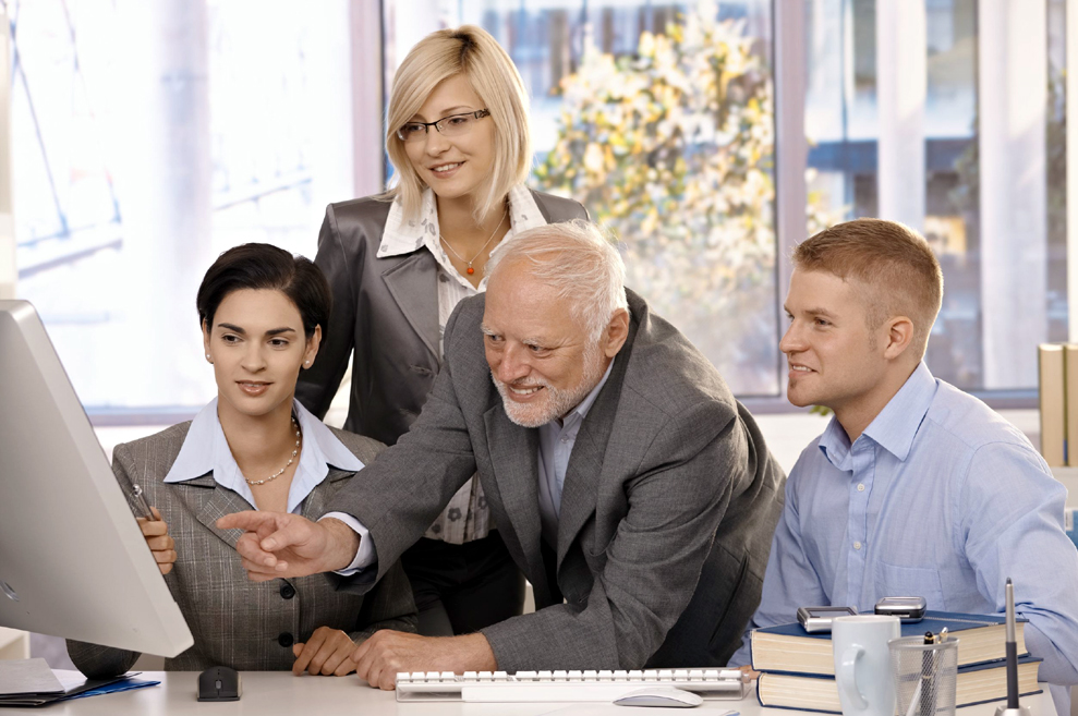 Four People Working on a Computer